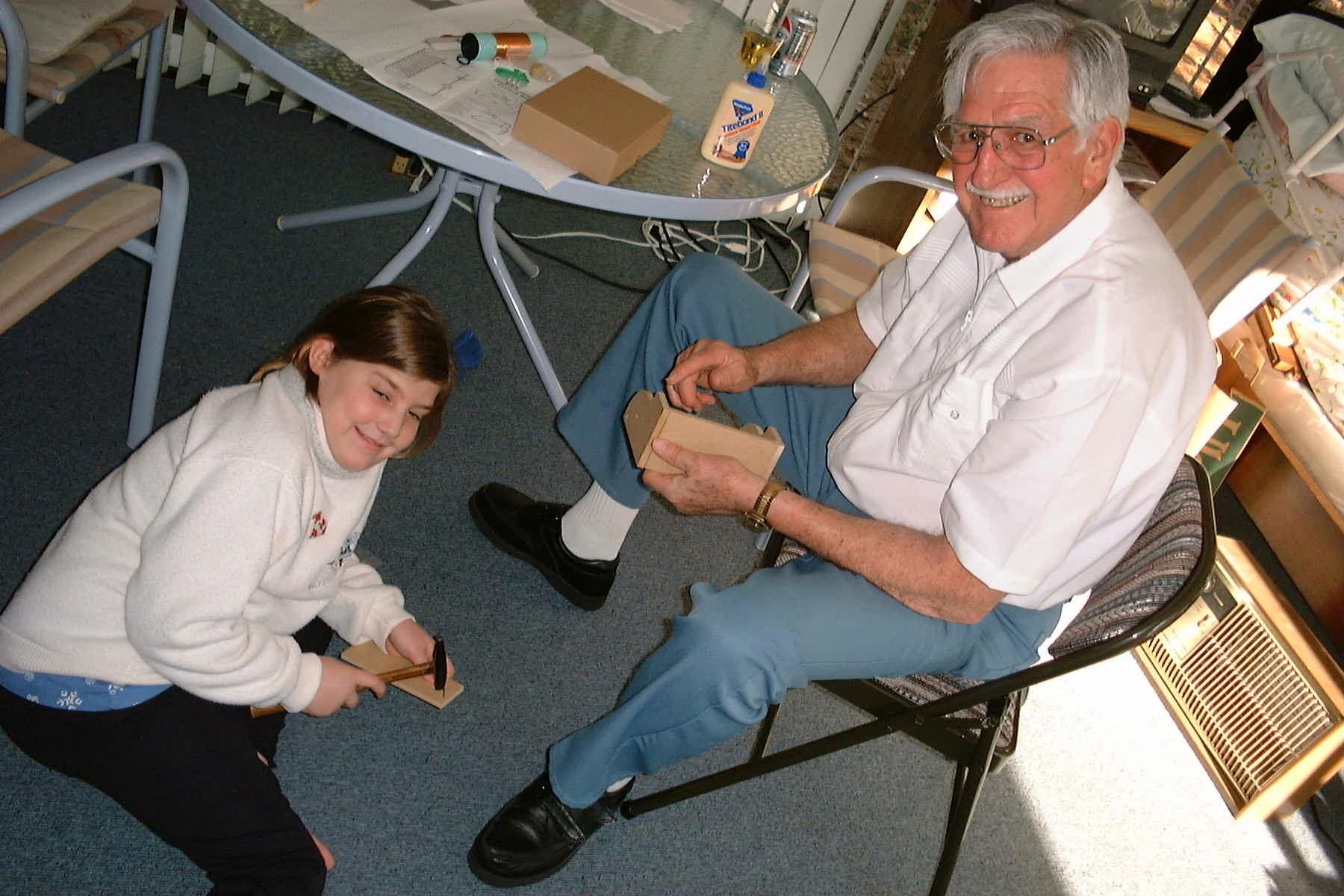 Danielle and Pop Pop building a crystal radio kit